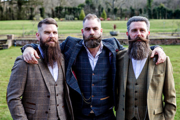 Smart Men with beard and moustache wearing a suit near a castle