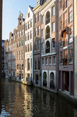 Fototapeta na wymiar Houses and Boats on Amsterdam Canal