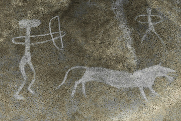 A hunting scene of an ancient man on a wild animal on a cave wall.