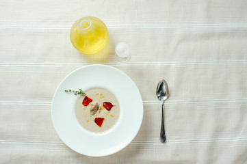 exquisite mushroom soup puree with pepper, table setting, cozy restaurant serve on a light background