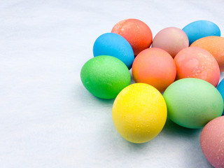Color easter eggs on pastel blue background. Close up.