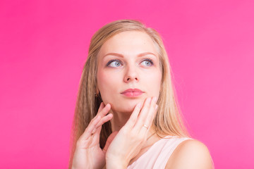 Close up portrait of a confident young blond woman smiling