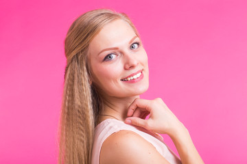Happy Blonde Woman on pink background. Smiling Fashion Model with Hairstyle