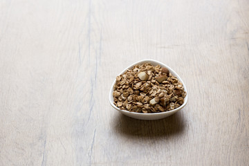 bowl of healthy granola on wooden background