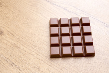 detail of delicious chocolate bar on wooden table