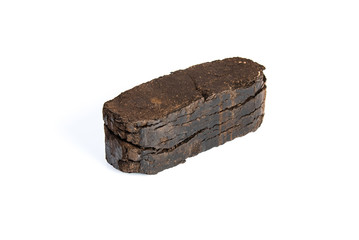 Peat briquette isolated on white background, alternative fuels