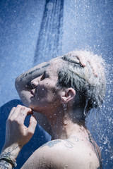 woman in shower with colorful steam