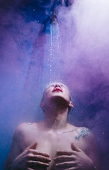 woman in shower with colorful steam