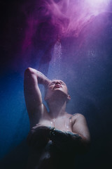 Fototapeta na wymiar woman in shower with colorful steam