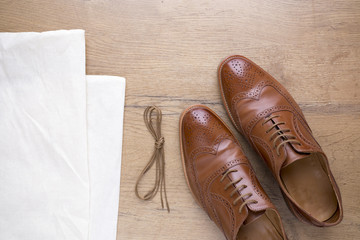 classic brown leather shoes on wooden floor
