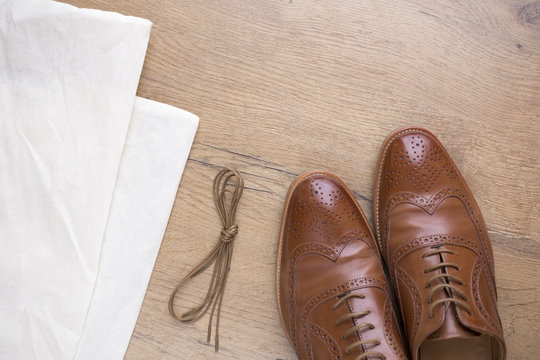 classic brown leather shoes on wooden floor
