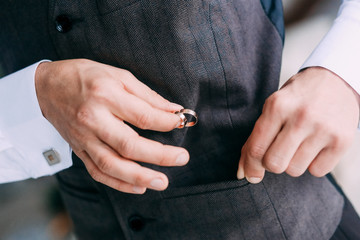 man groom charges ring pocket vest
