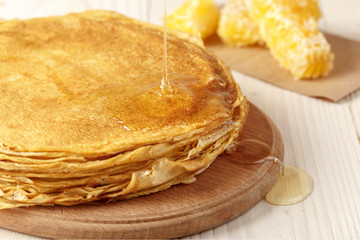A pile of thin pancakes on the table