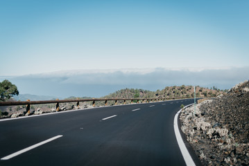 Highway goes to the right through the canyon near the clouds. Teide National Park. Tenerife
