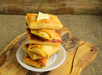  Pancakes are put by the hill on a plate. Pancakes have stuffing. Traditional dish of Belarusian cuisine