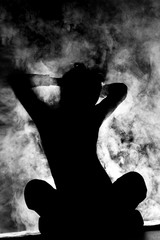 girl stretching silhouette with smoke
