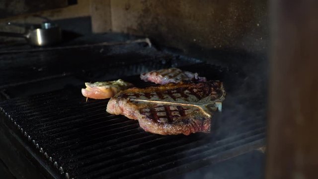 cooking grilled steak in a steak house