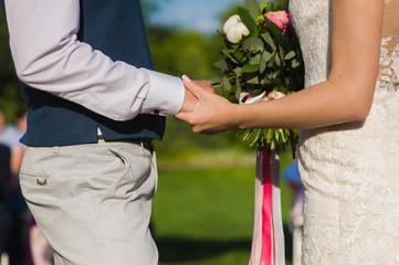 Obraz na płótnie Canvas Groom holding hand of his bride