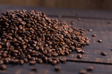 roasted coffee beans on dark wooden table