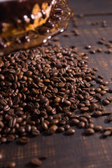icing biscuit cake soaked in cream on a dark wooden table with coffee beans