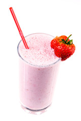 Glass of strawberry milkshake with fruits