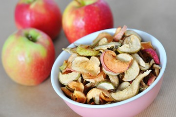 bowl of sun dried apple chips and fresh apples in the background, homemade healthy snack - 191789458