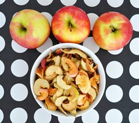 bowl of sun dried apple chips and fresh apples in the background, homemade healthy snack - 191789464