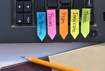 colorful stickers on a laptop with successful business strategy steps