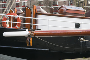 Details of sail deck and disconnected mast under maintenance illustrating concept of sailing and water travel. Harbor of Rotterdam, Netherlands.