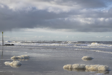 Low tide at Scheveningen beach near the Hague, the Netherlands, featuring blue skies. North sea natural background in January.
