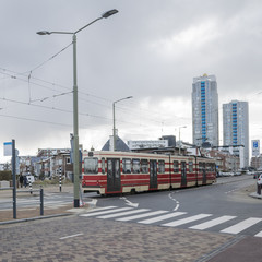 Fototapeta premium Details of street infrastructure with pedestrian crossing and bicycle lane and tram car crossing street in the Hague, Netherlands. 