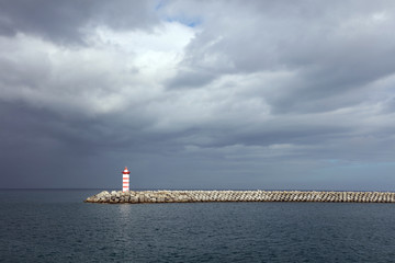 Lighthouse against a stormy sky background