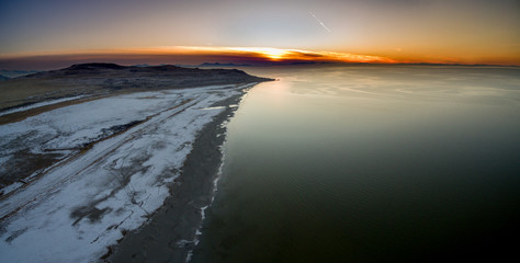 Fototapeta na wymiar Aerial seascape of a coastline during a golden sunset