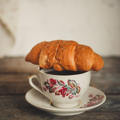 croissant and a cup of coffee