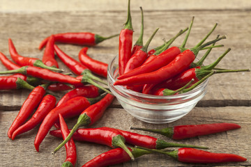 bunch fresh raw red hot chilli pepper on a wooden background tie