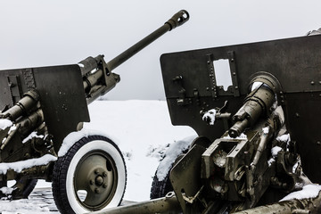 gun of world war in a pine forest on snow at winter