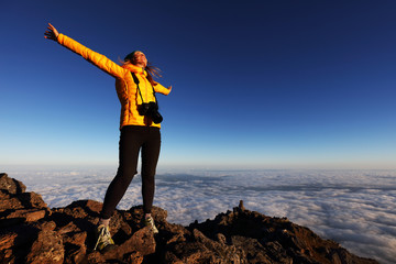 Young girl trekking and taking photos on Pico volcano (2351m) on Pico Island, Azores, Portugal, Europe