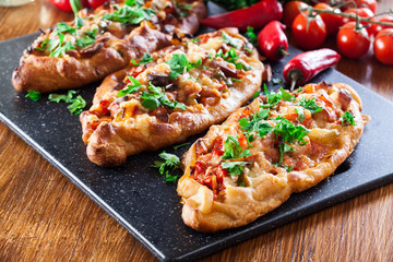 Traditional Turkish pide with meat and vegetables