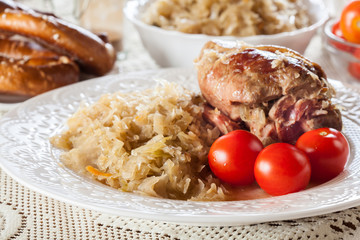 Pork knuckle with fried sauerkraut and tomatoes