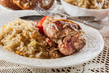 Pork knuckle with fried sauerkraut and tomatoes