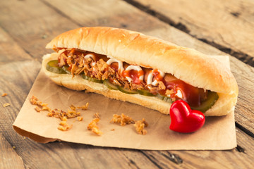 Hotdog with two sausiges and onion chips.