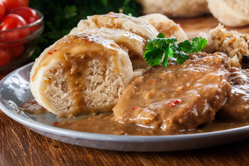 Pork loin in gravy with bread dumplings and sauerkraut