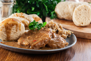 Pork loin in gravy with bread dumplings and sauerkraut