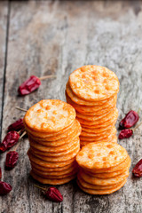 Round  shape rice cracker with chili pepper on wooden table