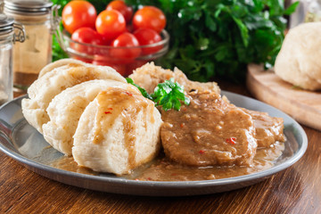 Pork loin in gravy with bread dumplings and sauerkraut