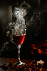 Romantic scene with smoke, wine Glass and Fireplace