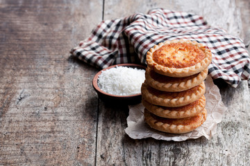 Stack  of coconut tarts on wooden table
