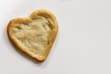 Homemade Half baked heart shaped Pizza crust isolated on white