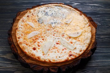 Delicious quattro formaggi pizza with pear. Italian food, Restaurant menu concept