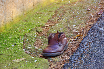 Abandoned single shoe near road